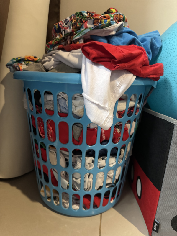 Poner la ropa en la canasta de la ropa sucia